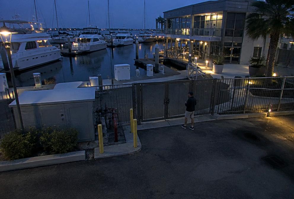 Night view of a marina pontoon with a person flagged by AI