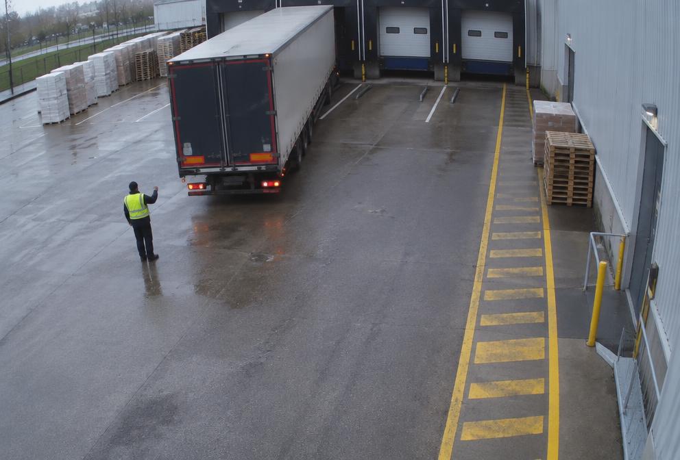 Warehouse loading bay with truck and worker monitored by AI