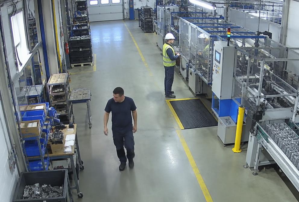 Industrial worker in helmet and hi-vis vest highlighted by an AI PPE detection box