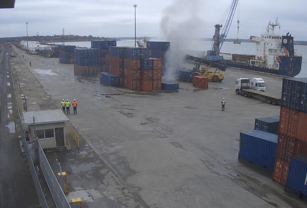 Camera view of smoke rising in a port container yard with an AI detection box