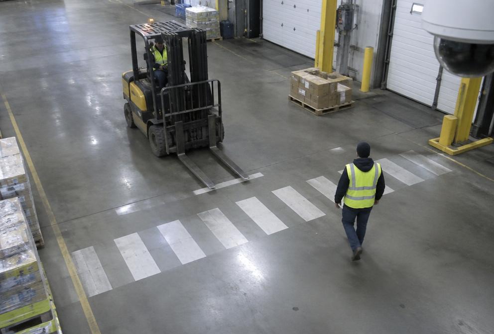 Forklift and pedestrian close together in a terminal, flagged by AI